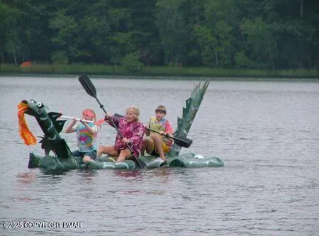 a car parked in front of a house with large trees