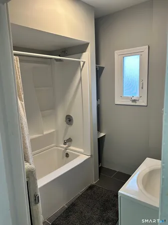 a bathroom with a bathtub and a sink