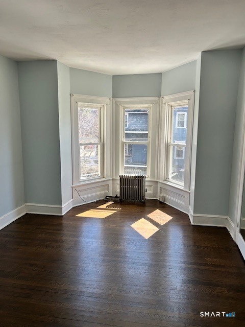 59 Park Place Middletown, CT 06457 - Photo 9 of 13 an empty room with wooden floor and windows