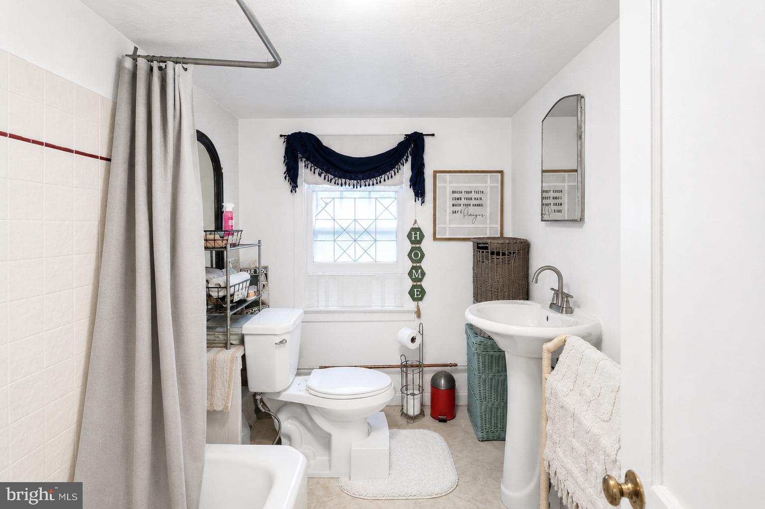 1470 River Road Titusville, NJ 08560 - Photo 45 of 50 a white toilet sitting next to a bathroom sink and vanity