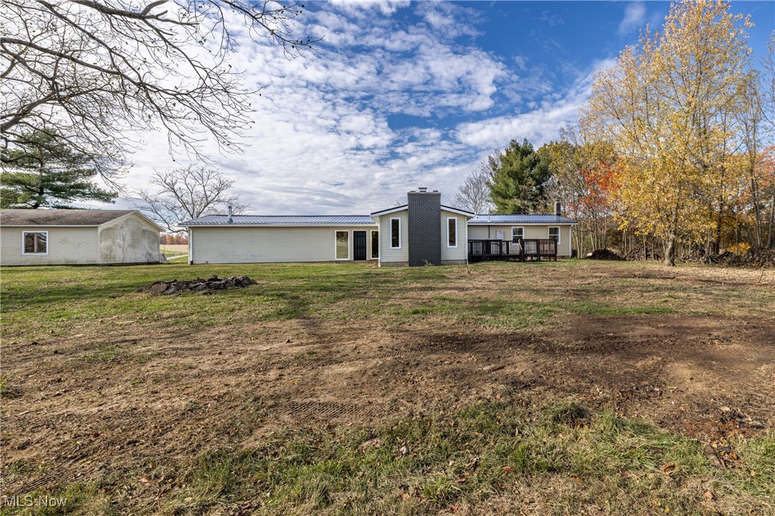 24534 Mill Road Utica, OH 43080 - Photo 31 of 38 Rear view of house featuring a yard and a chimney