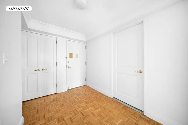 a view of a room with a wooden floor and closet