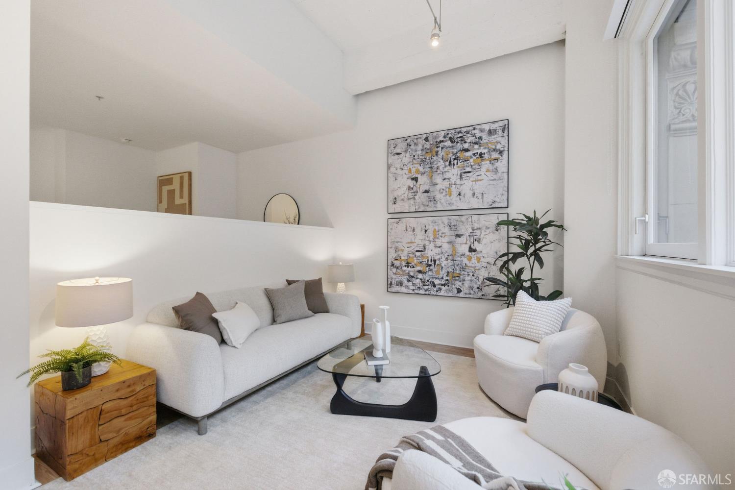 74 New Montgomery Street, Unit 211 San Francisco, CA 94105 - Photo 7 of 22 a living room with furniture and white walls