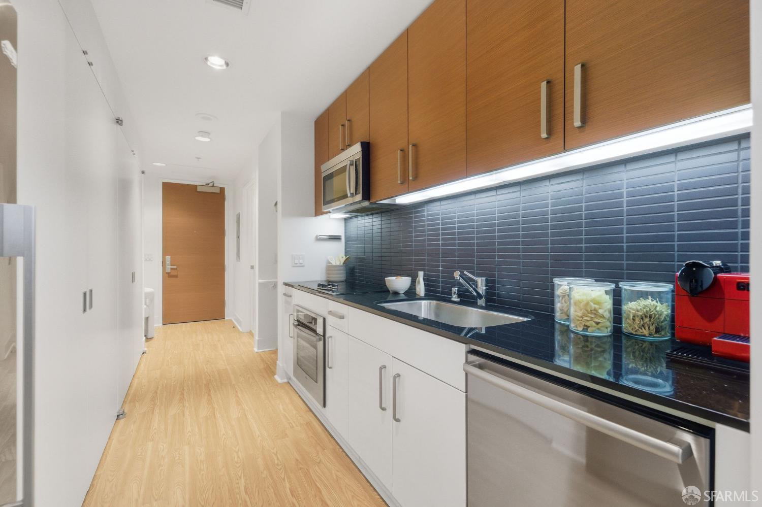 74 New Montgomery Street, Unit 211 San Francisco, CA 94105 - Photo 9 of 22 a kitchen with sink cabinets and stove