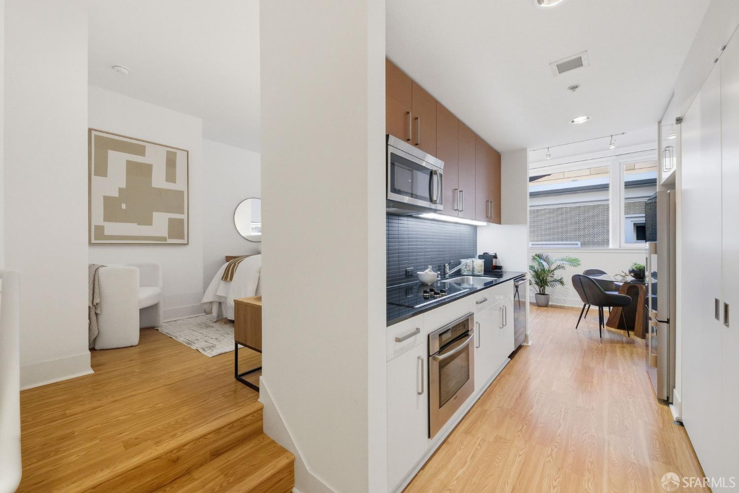 74 New Montgomery Street, Unit 211 San Francisco, CA 94105 - Photo 10 of 22 a kitchen with sink cabinets and wooden floor