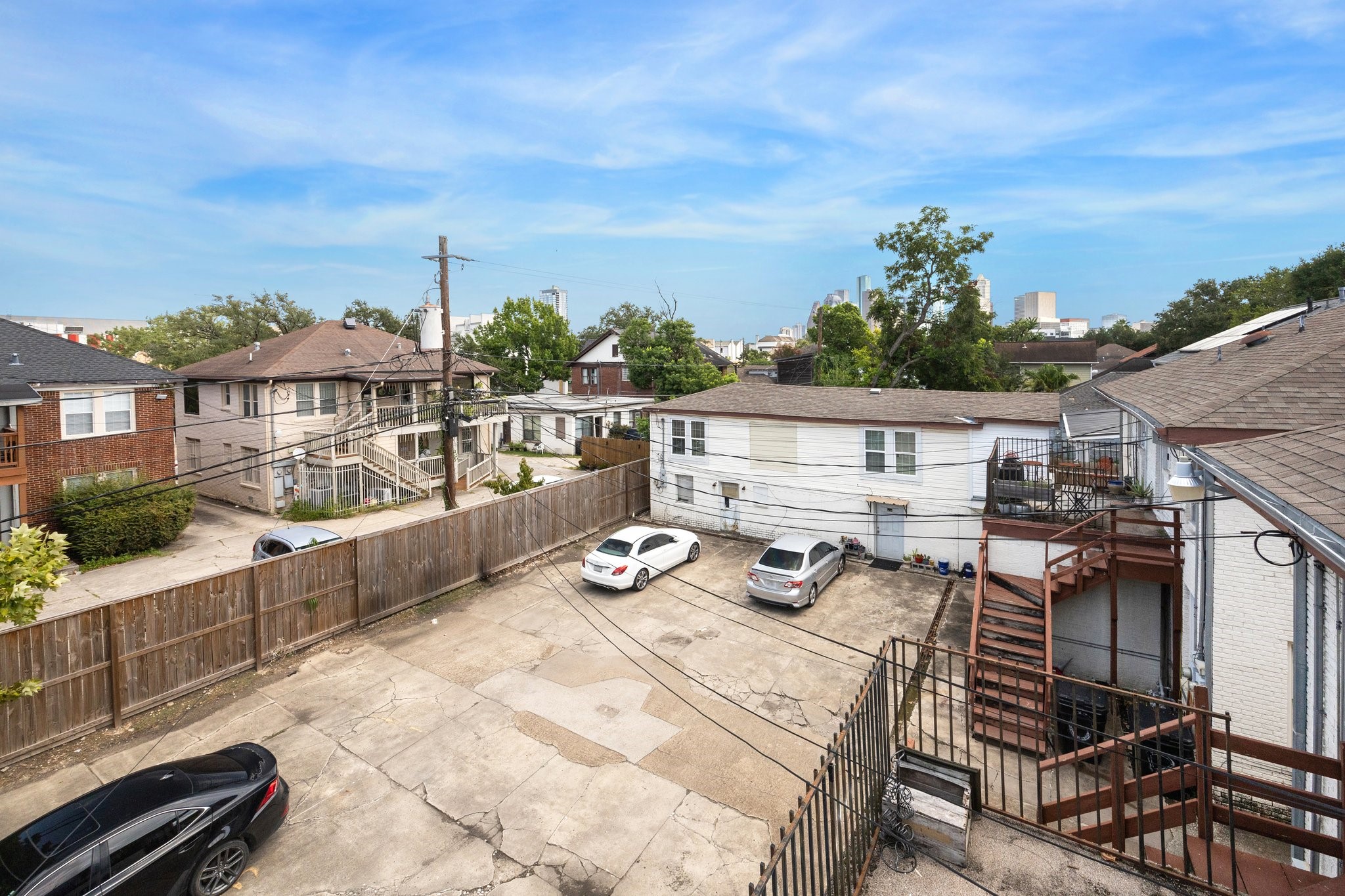 918-920 Peden Street Houston, TX 77006 - Photo 12 of 13 a view of a patio with couches table and chairs with wooden floor