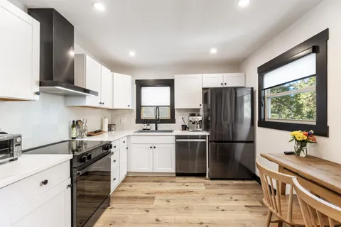 a bedroom with a large bed and a painting on the wall
