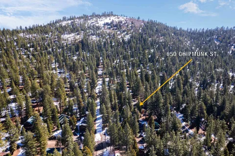 a view of a patio with a table and chairs and wooden fence
