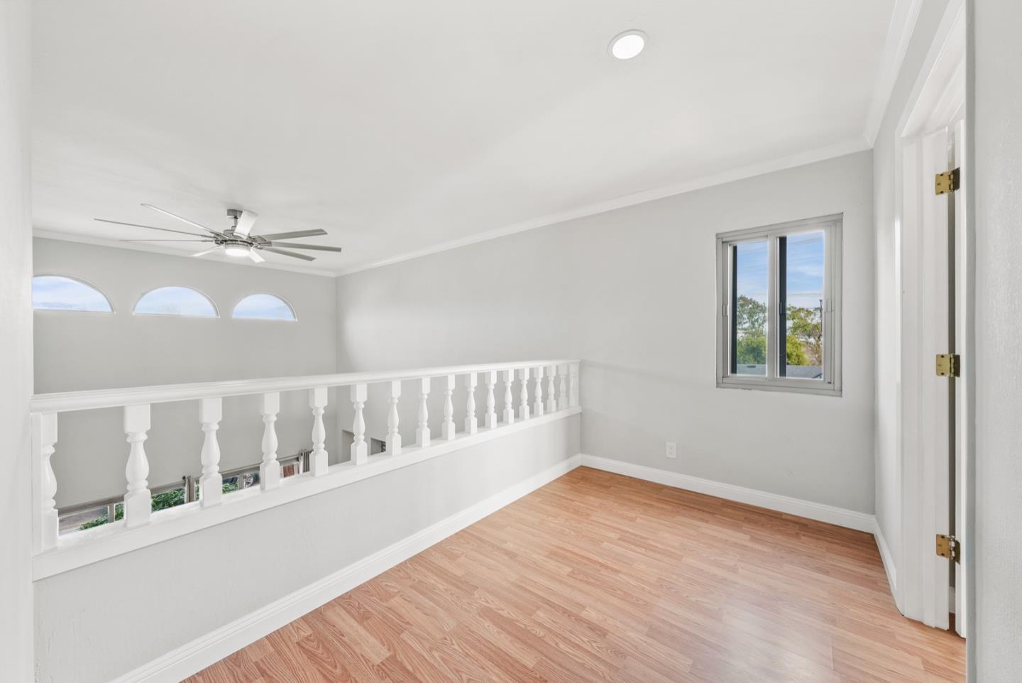 346 Cedar Street Millbrae, CA 94030 - Photo 12 of 43 an empty room with wooden floor fan and windows