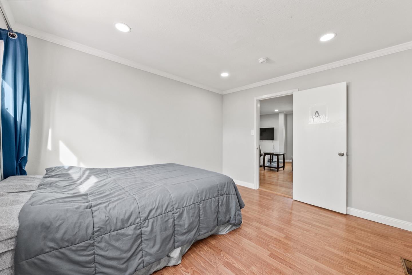 346 Cedar Street Millbrae, CA 94030 - Photo 21 of 43 a spacious bedroom with a bed and a flat screen tv