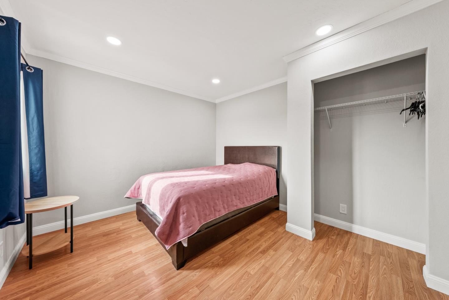 346 Cedar Street Millbrae, CA 94030 - Photo 25 of 43 a bedroom with a bed and wooden floor