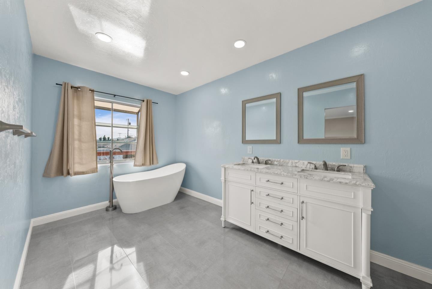 346 Cedar Street Millbrae, CA 94030 - Photo 27 of 43 a spacious bathroom with a bathtub sink and mirror