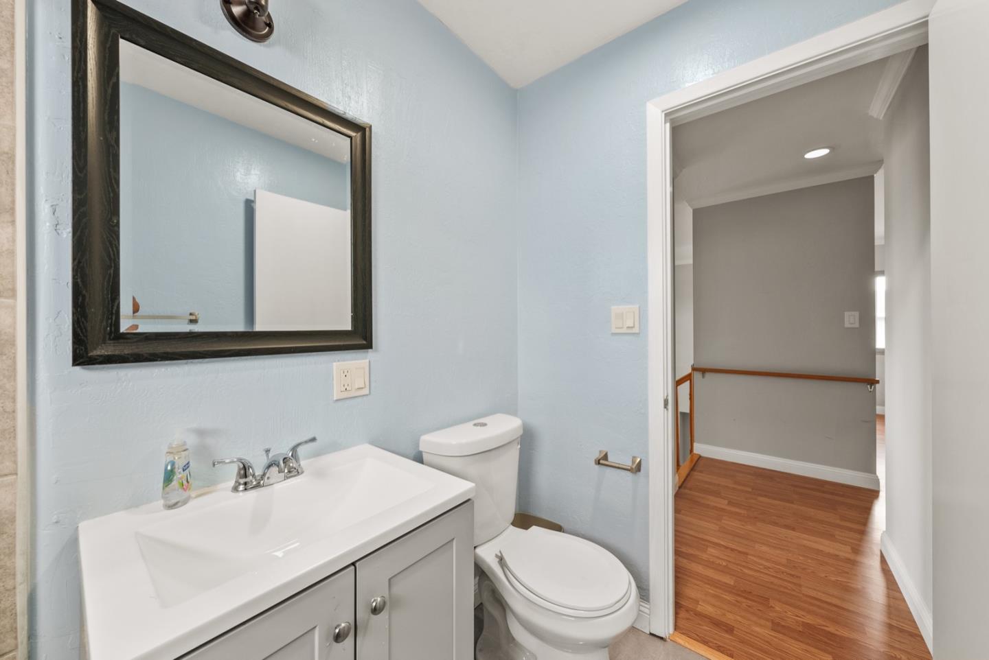 346 Cedar Street Millbrae, CA 94030 - Photo 33 of 43 a bathroom with a toilet a sink a vanity and mirror