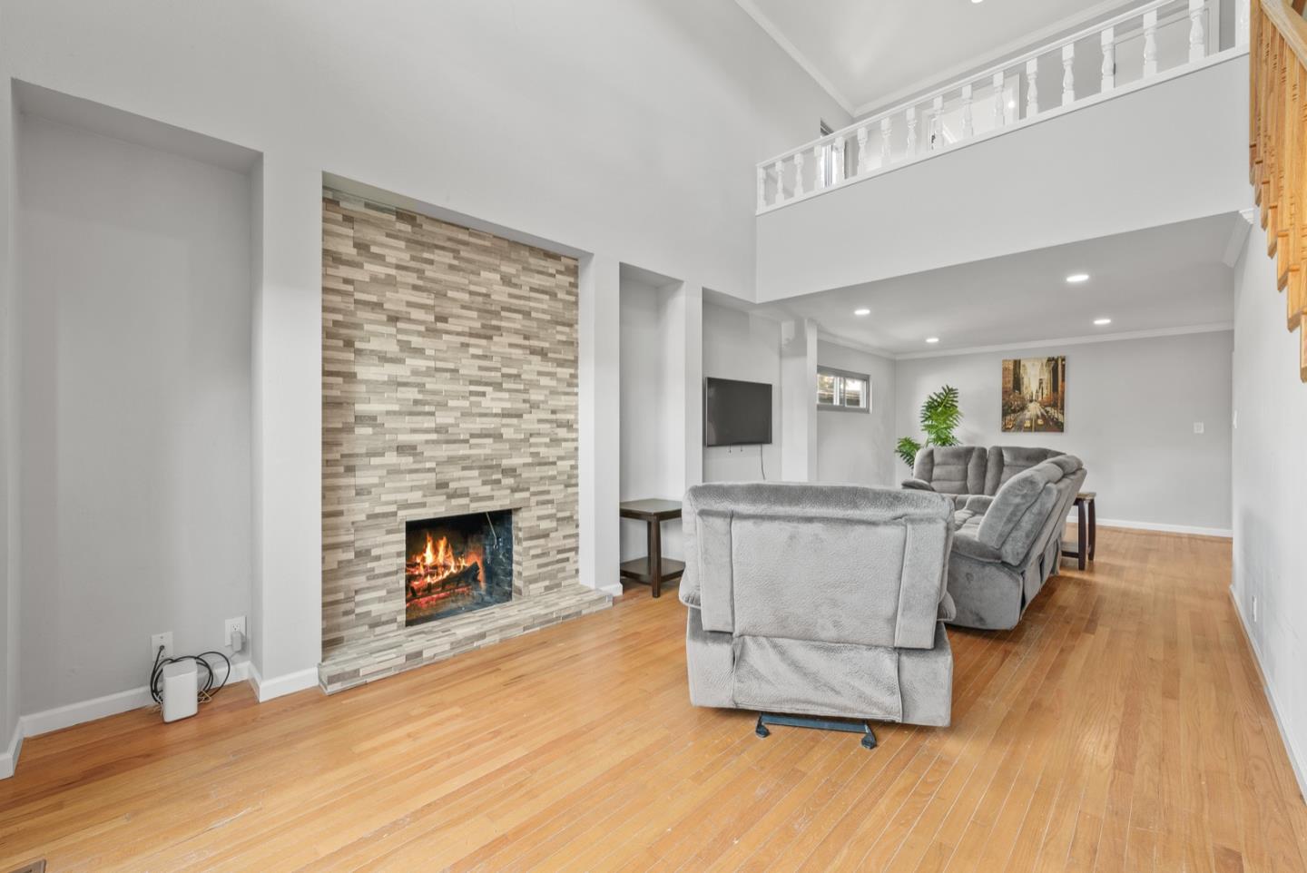 346 Cedar Street Millbrae, CA 94030 - Photo 5 of 43 a living room with furniture a fireplace and a wooden floor