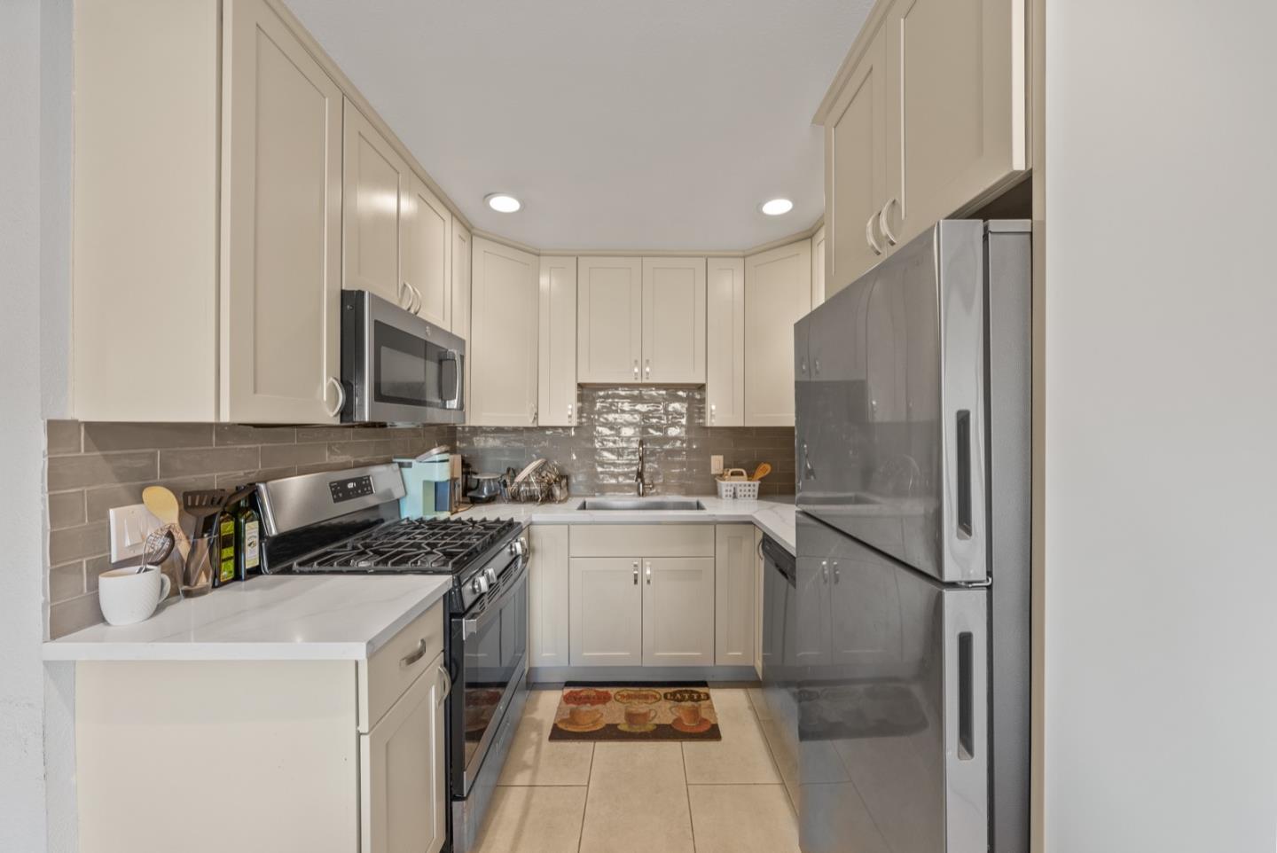 346 Cedar Street Millbrae, CA 94030 - Photo 7 of 43 a kitchen with a stove a refrigerator and a sink