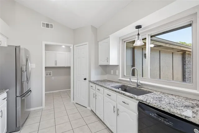 a kitchen with a sink stove and refrigerator