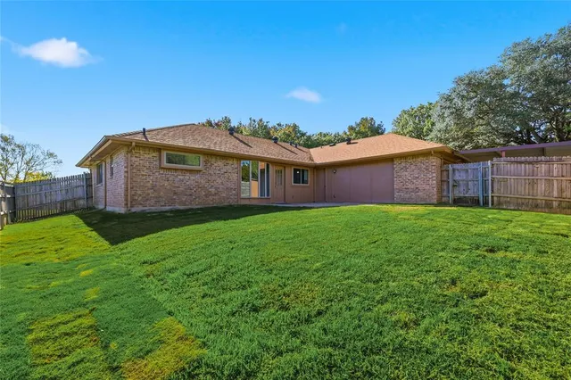 a front view of house with a garden