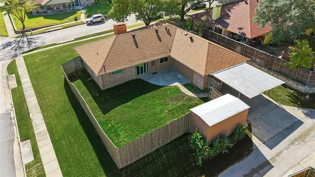 an aerial view of residential house with outdoor space and trees