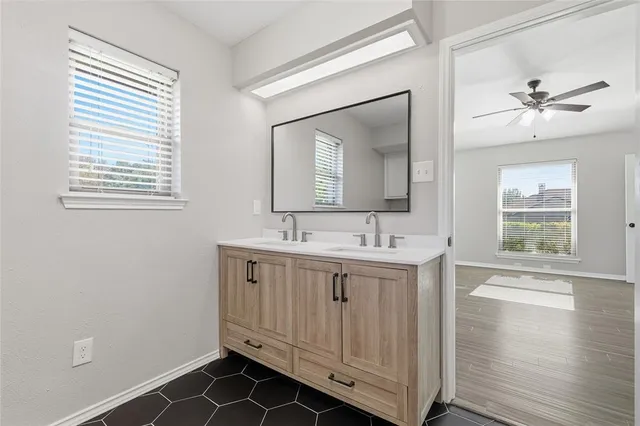 a bathroom with a double vanity sink and a mirror