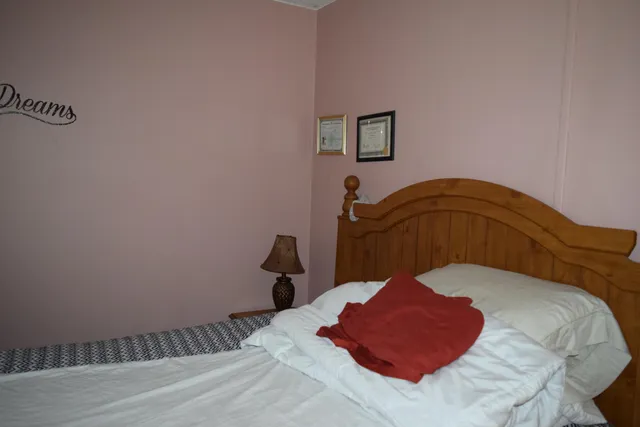 a bedroom with a bed and a dresser