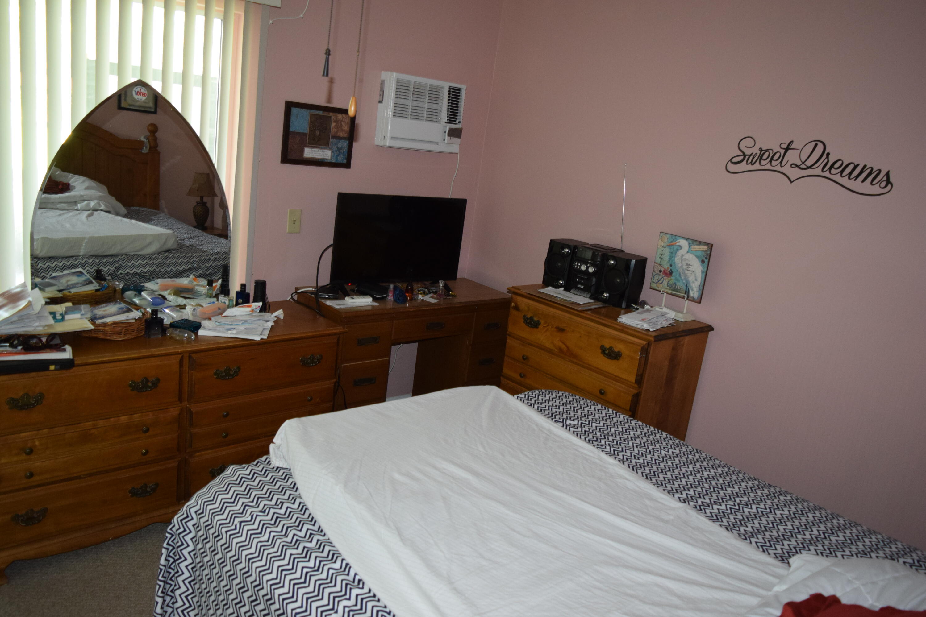 58 Sussex C, Unit C West Palm Beach, FL 33417 - Photo 14 of 22 a bedroom with a bed and a flat screen tv