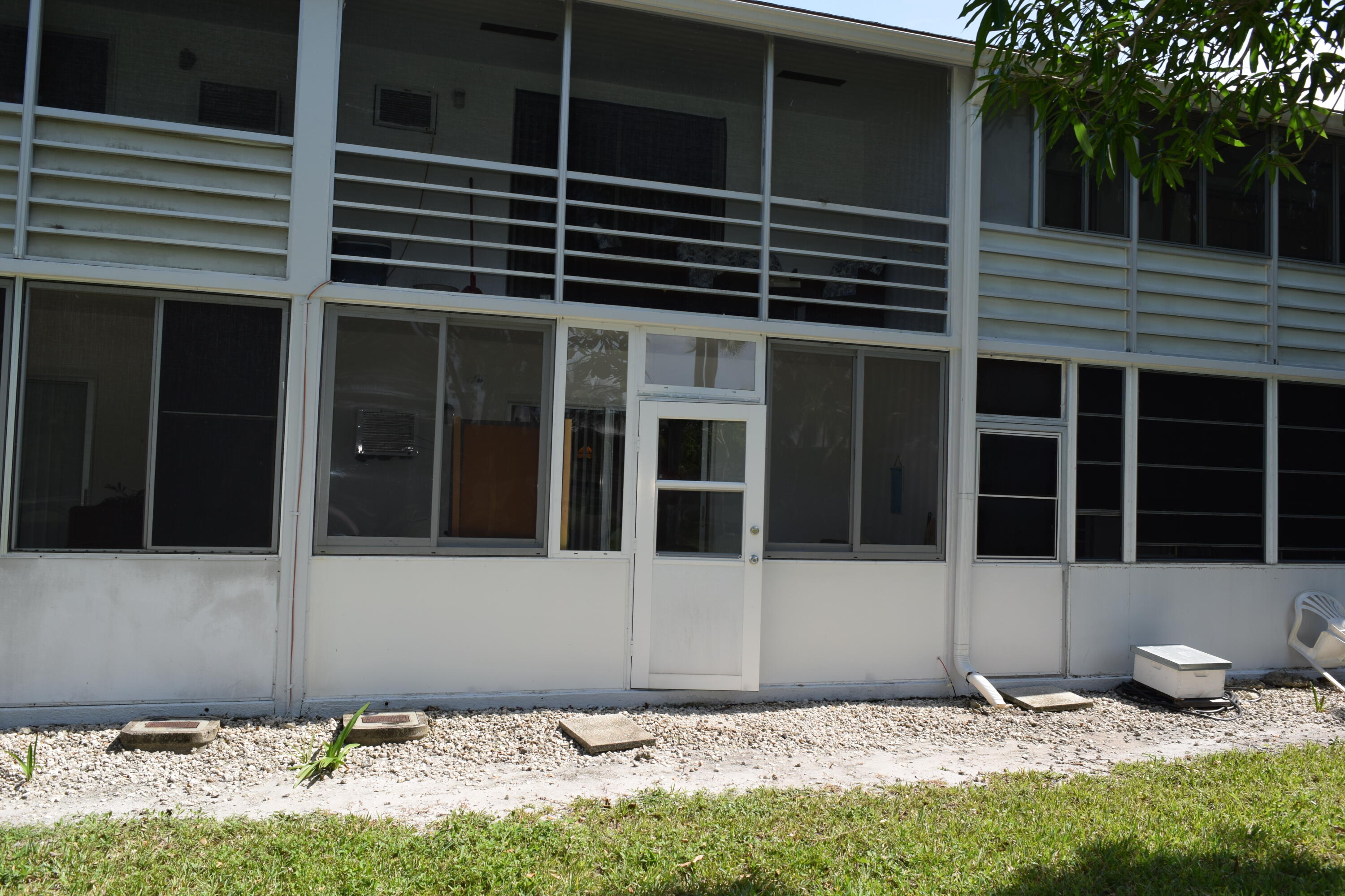 58 Sussex C, Unit C West Palm Beach, FL 33417 - Photo 16 of 22 a front view of a house with windows