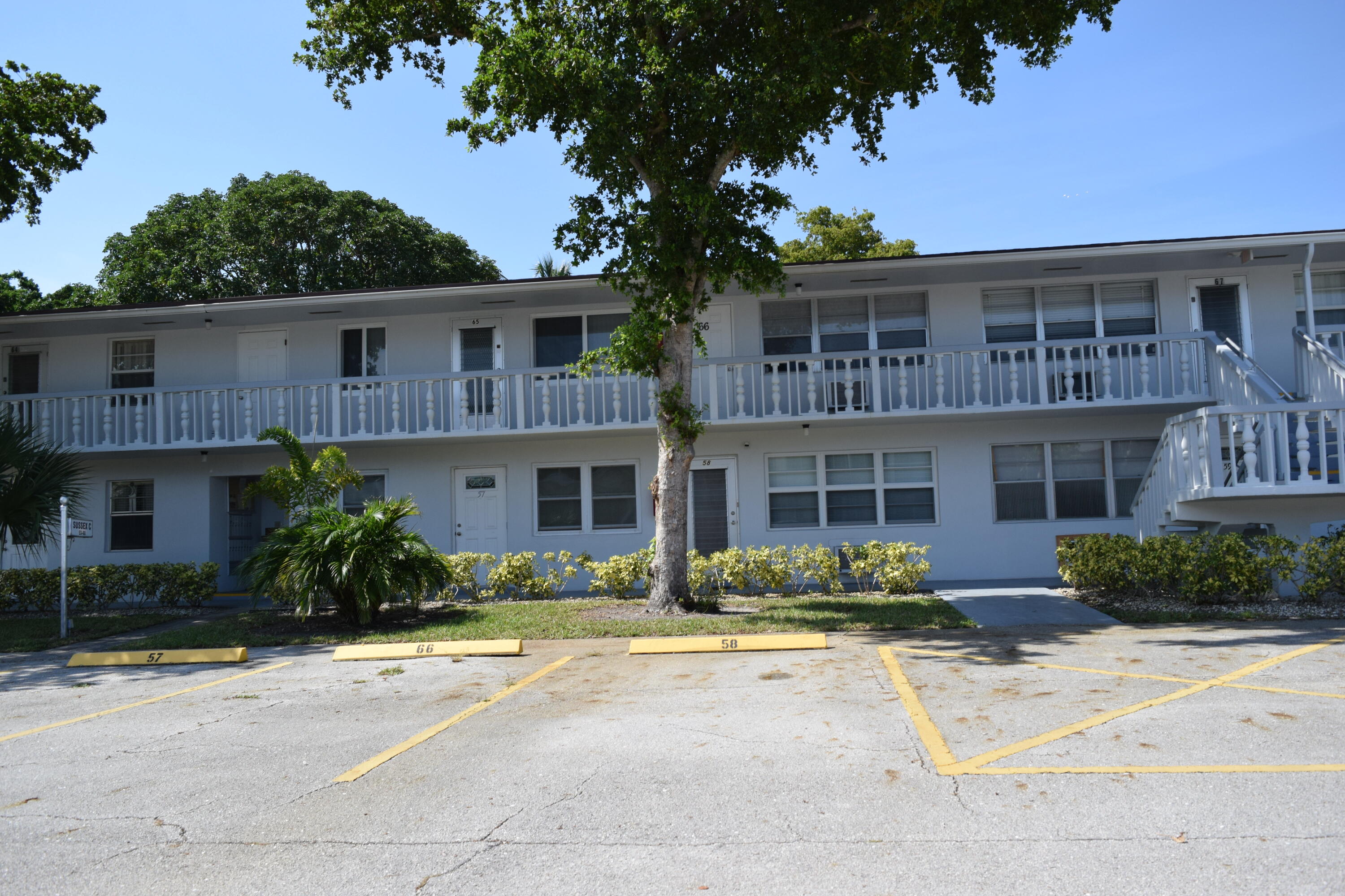 58 Sussex C, Unit C West Palm Beach, FL 33417 - Photo 21 of 22 a front view of a house with yard