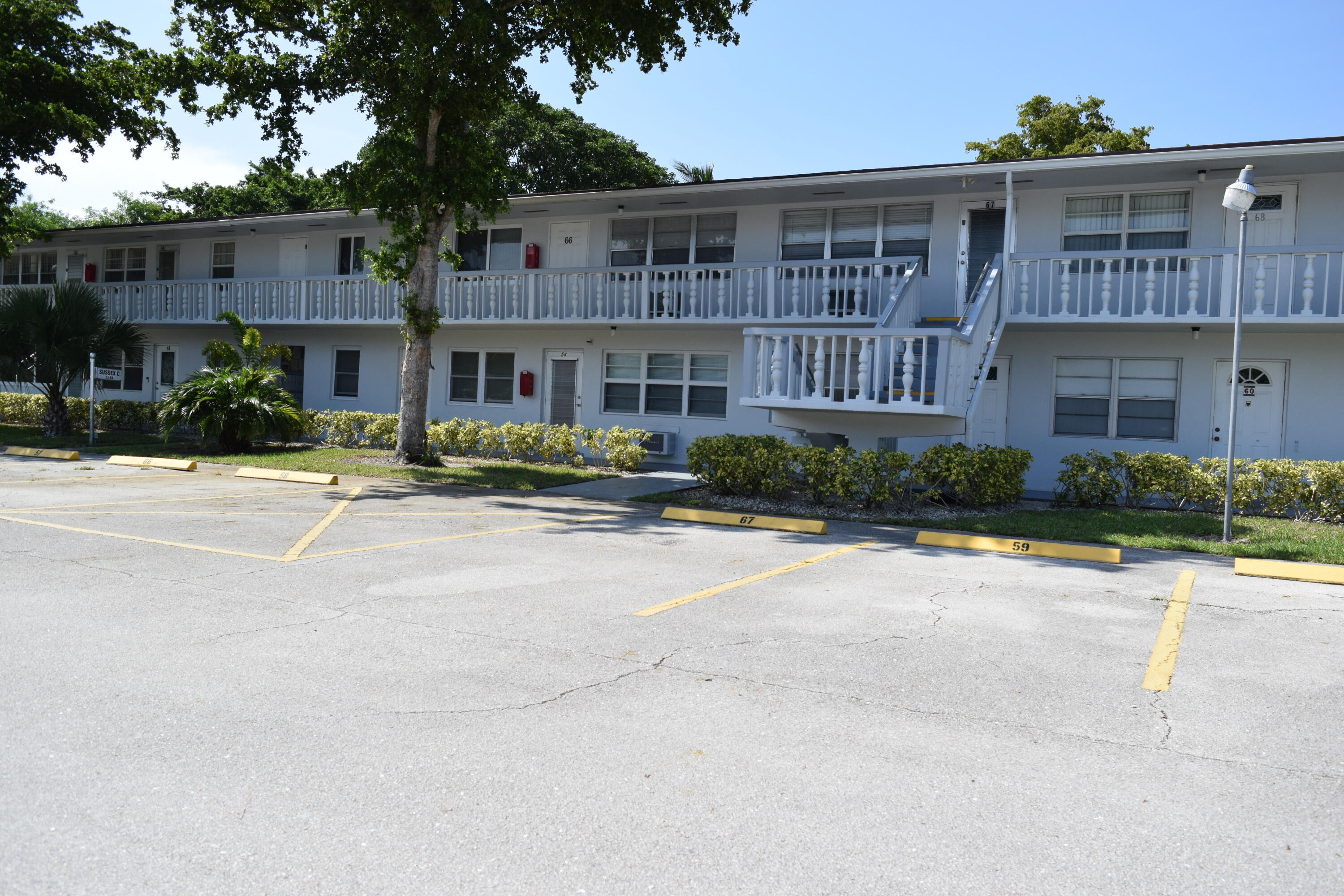 58 Sussex C, Unit C West Palm Beach, FL 33417 - Photo 22 of 22 a front view of multiple houses with yard