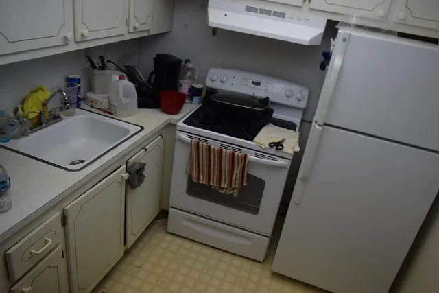 a kitchen with storage and utility