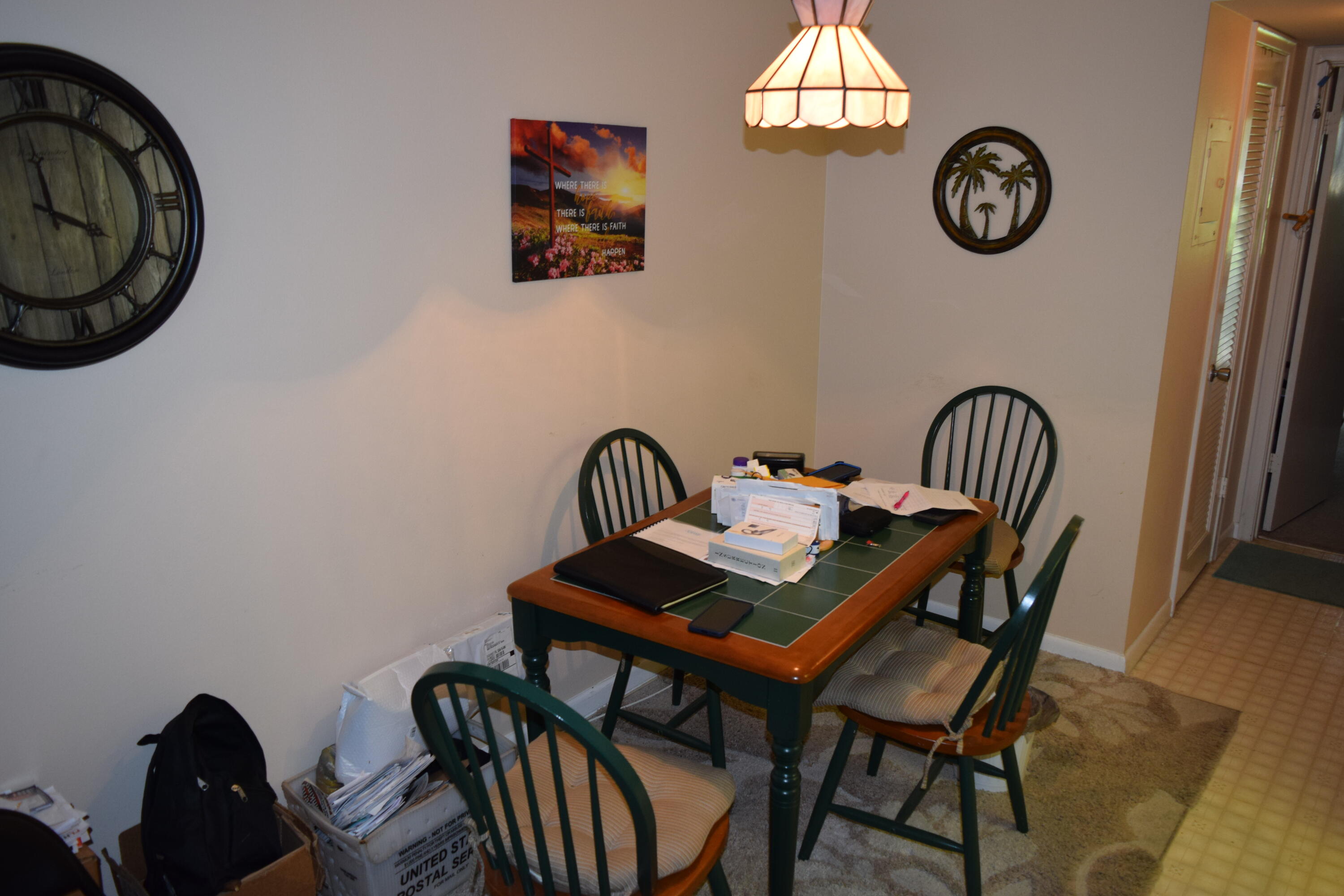 58 Sussex C, Unit C West Palm Beach, FL 33417 - Photo 9 of 22 a view of a dining room that has a table and a chair