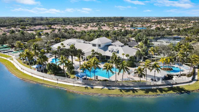 an aerial view of residential houses with outdoor space and ocean view