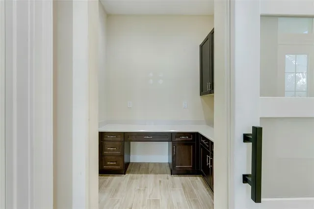 a view of walk in closet with wooden floor