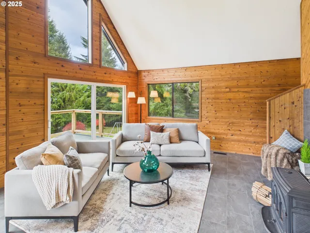 a living room with furniture and a floor to ceiling window