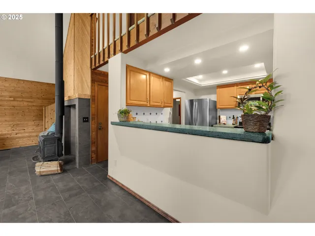 a kitchen with stainless steel appliances granite countertop a sink a stove cabinets and wooden floor