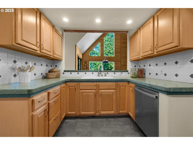 a kitchen with stainless steel appliances a sink stove and a refrigerator