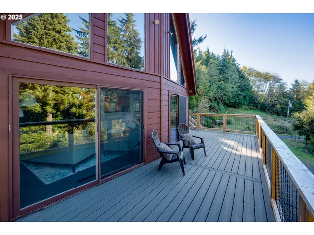 a view of balcony with wooden floor and seating space