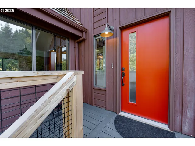 a balcony with wide window and wooden floor