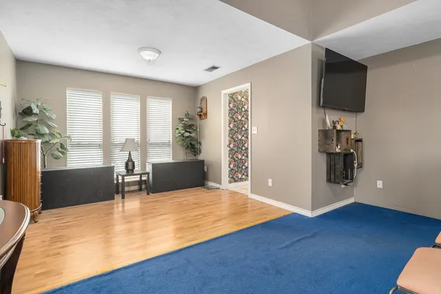 a view of a living room a dining room with furniture