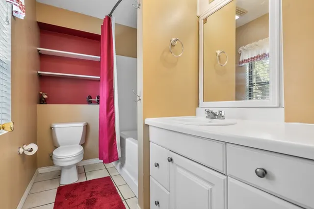 a bathroom with a sink and a mirror with toilet