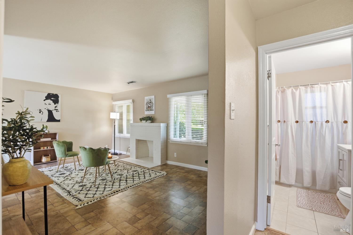 2015 Locust Street Napa, CA 94559 - Photo 15 of 54 a living room with dining table and a window with garden view