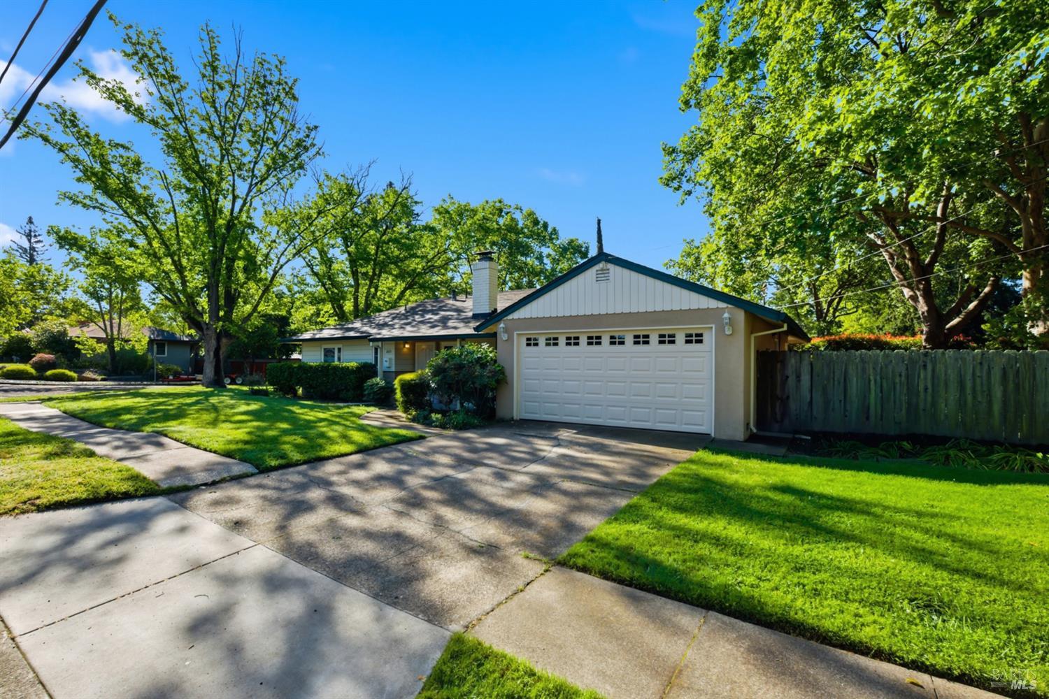 2015 Locust Street Napa, CA 94559 - Photo 2 of 54 a view of a sign board with a big yard and large trees