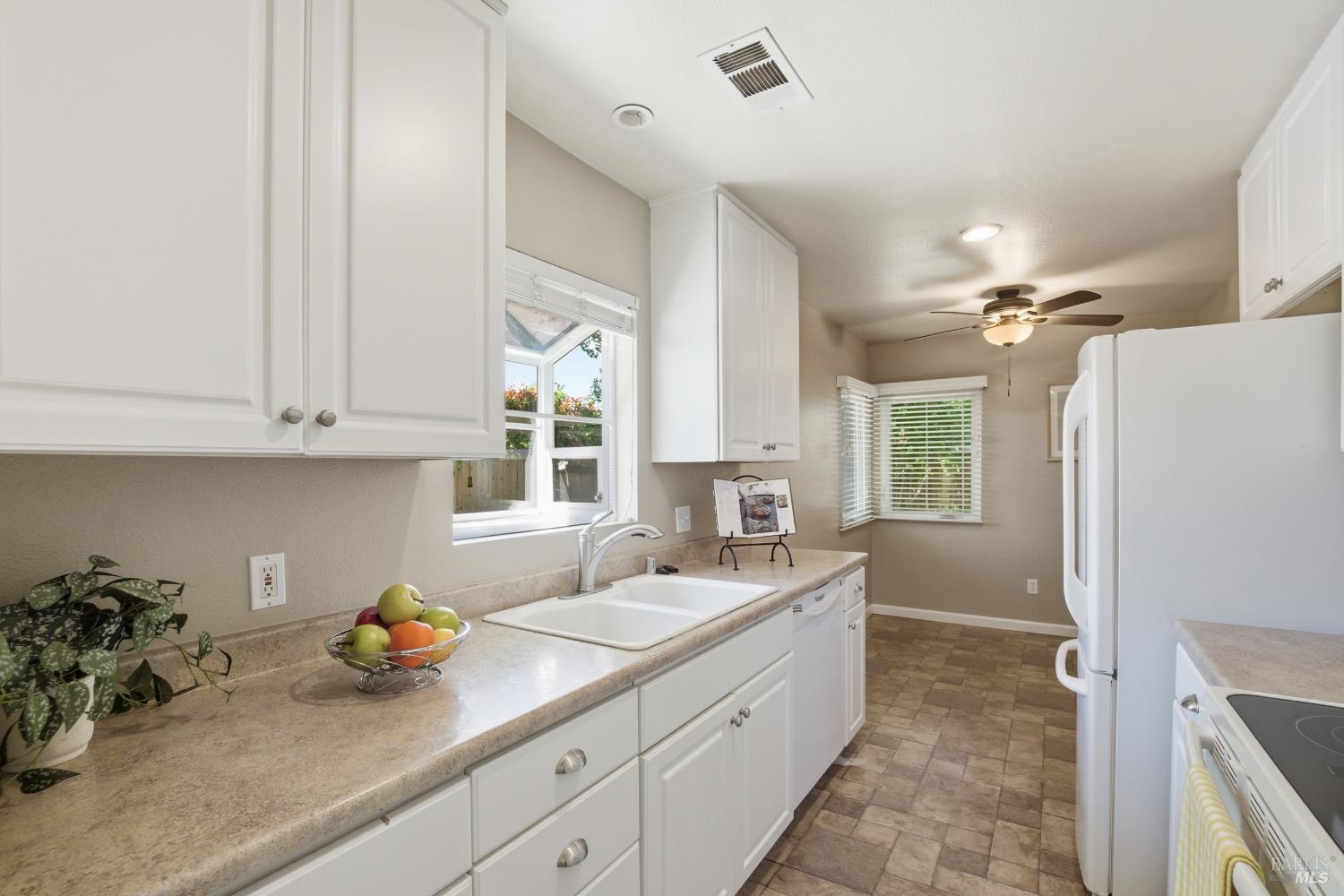 2015 Locust Street Napa, CA 94559 - Photo 27 of 54 a kitchen with a sink refrigerator and cabinets