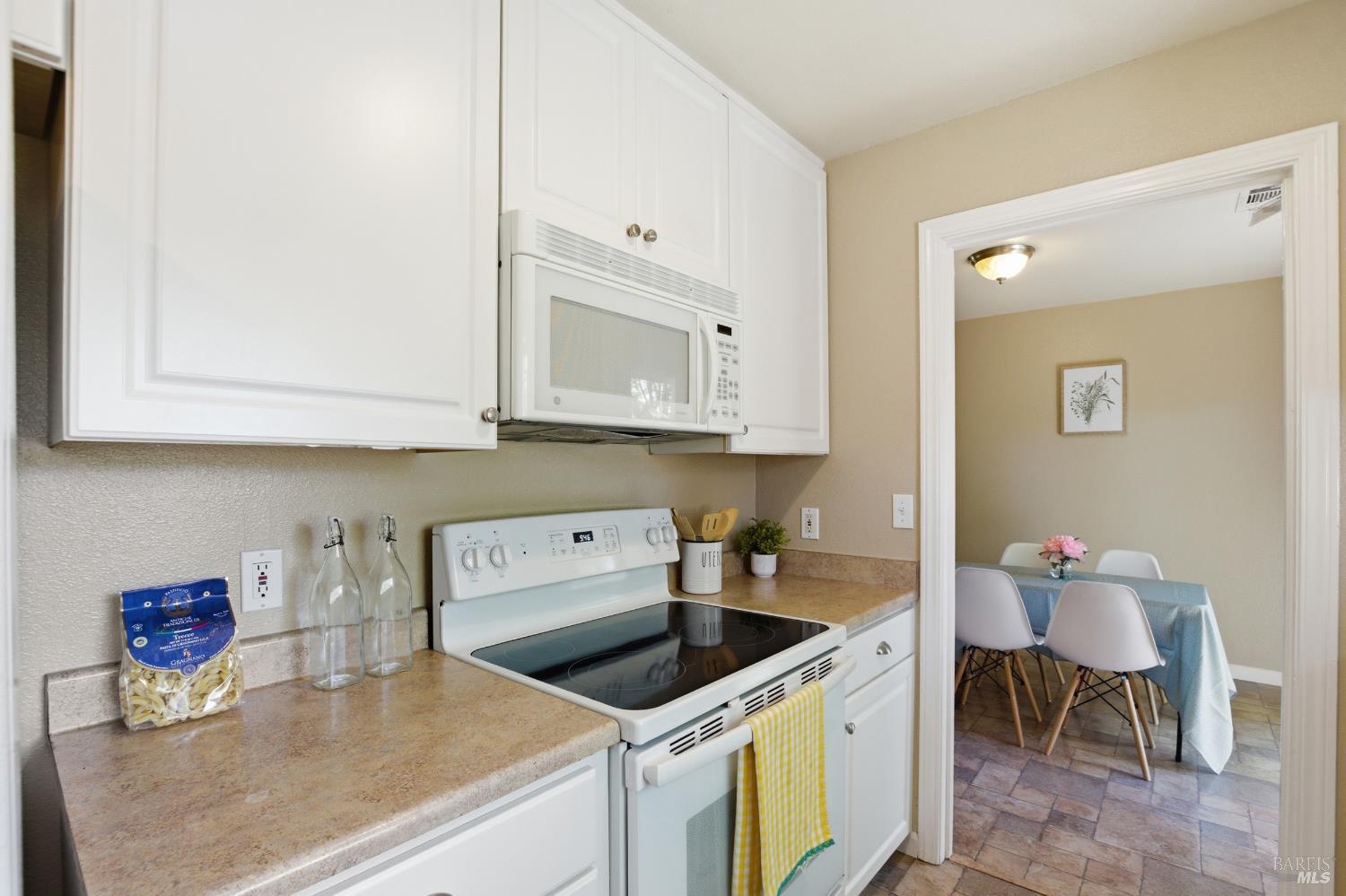 2015 Locust Street Napa, CA 94559 - Photo 32 of 54 a kitchen with stainless steel appliances granite countertop a white stove top oven a sink and dishwasher