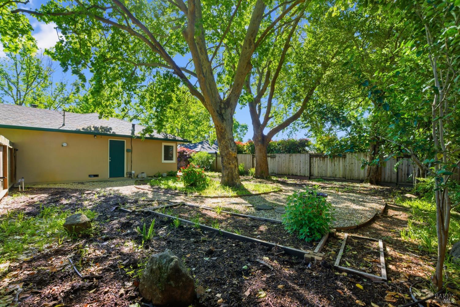 2015 Locust Street Napa, CA 94559 - Photo 40 of 54 a backyard of a house with table and chairs under an umbrella