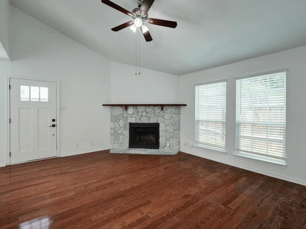 913 Sirocco Drive, Unit A & B Austin, TX 78745 - Photo 1 of 39 a view of an empty room with wooden floor fireplace and a window
