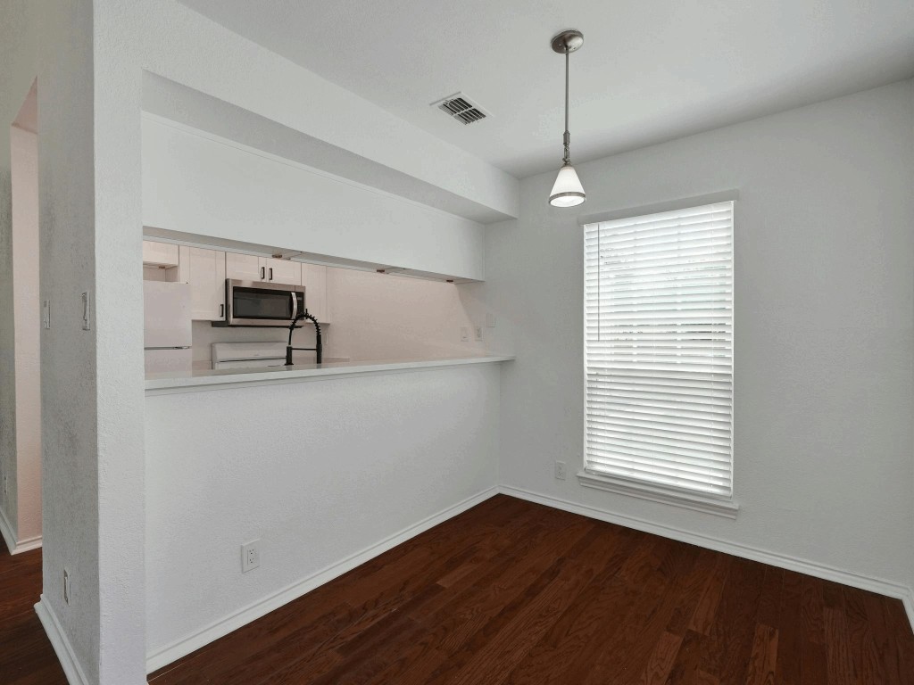 913 Sirocco Drive, Unit A & B Austin, TX 78745 - Photo 12 of 39 a view of empty room with wooden floor and window