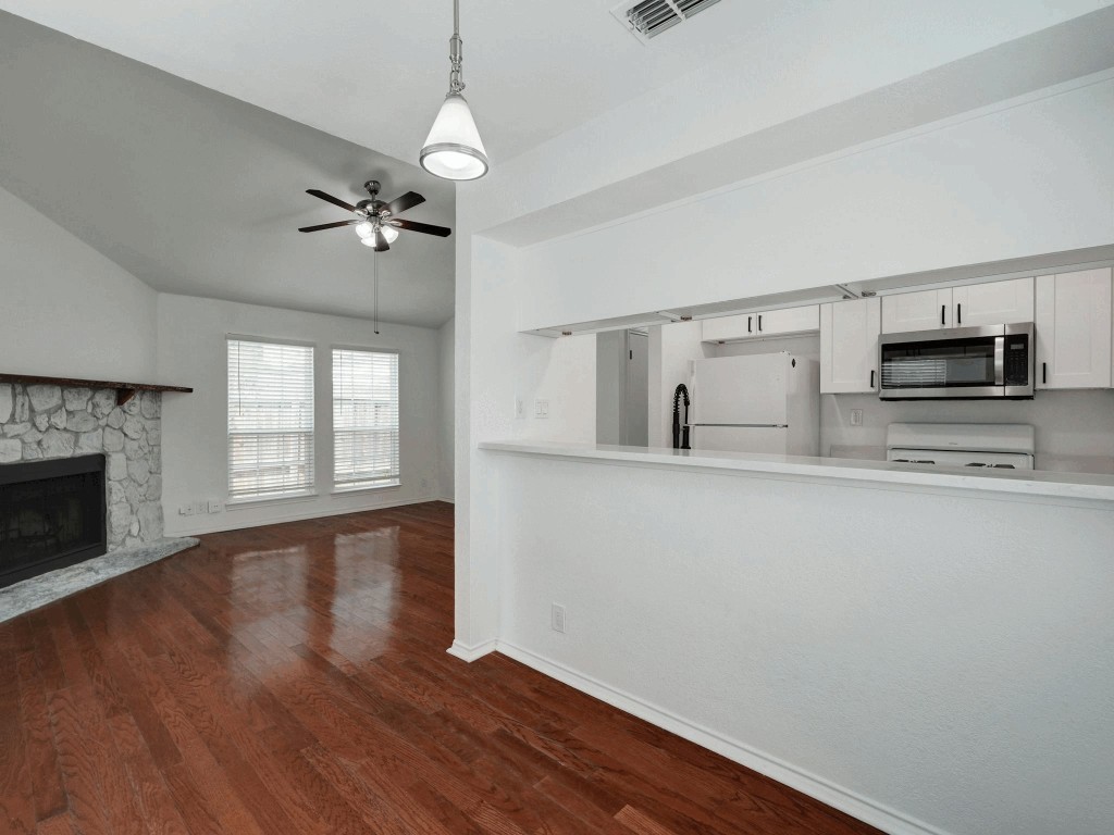 913 Sirocco Drive, Unit A & B Austin, TX 78745 - Photo 13 of 39 a view of kitchen with granite countertop cabinets stainless steel appliances and wooden floor