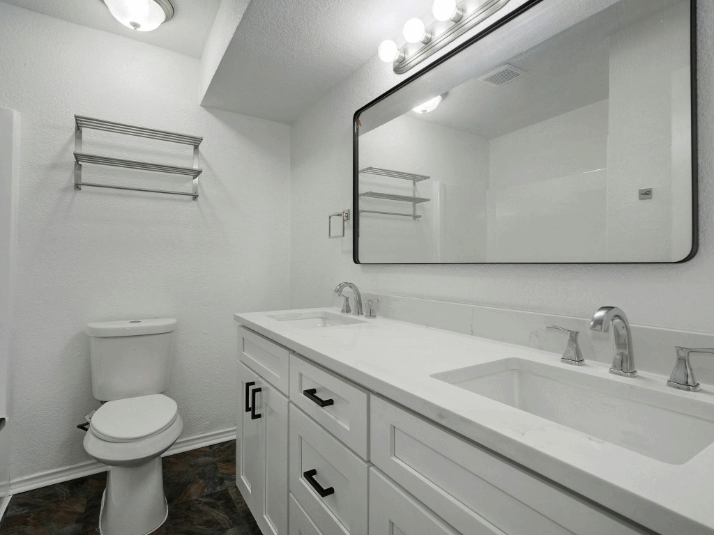913 Sirocco Drive, Unit A & B Austin, TX 78745 - Photo 16 of 39 a bathroom with a toilet sink and mirror