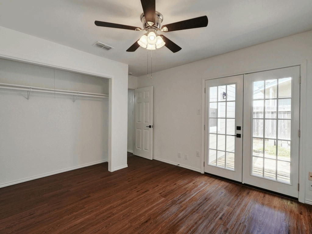 913 Sirocco Drive, Unit A & B Austin, TX 78745 - Photo 19 of 39 a view of an empty room with wooden floor and a window