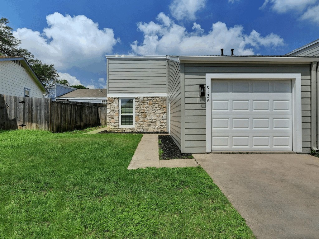 913 Sirocco Drive, Unit A & B Austin, TX 78745 - Photo 25 of 39 a front view of a house with a yard and garage